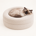 Ragdoll cat asleep in the Happy Cat Nest bed with its chin on the rim